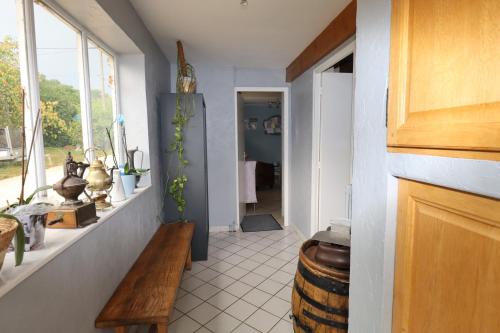 a hallway with a table and a barrel in a room at gite des 3 rivières in Longeault