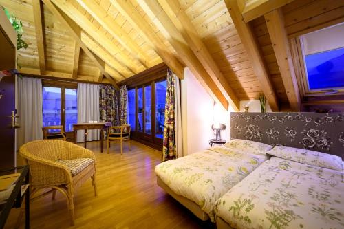 a bedroom with a bed and a table and chairs at Bernina Express Eco Rooms&Breakfast in Tirano
