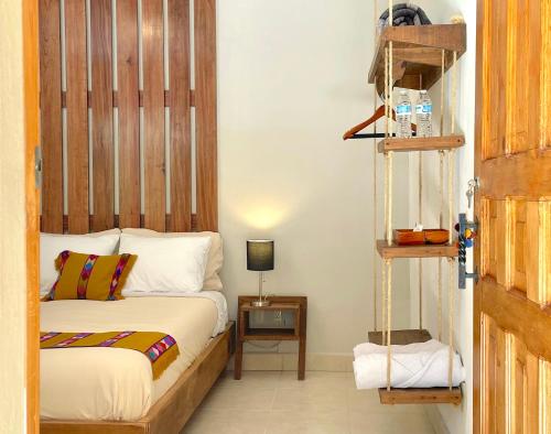 a bedroom with a bed with a wooden headboard at Hotel Casa Azabache in San Cristóbal de Las Casas