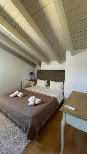 a bedroom with a bed with two towels on it at vraxleri house in Kassiopi