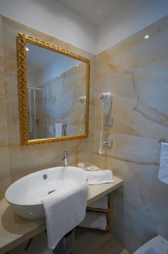 a bathroom with a white sink and a mirror at Hotel Villa Fulgida in Cattolica