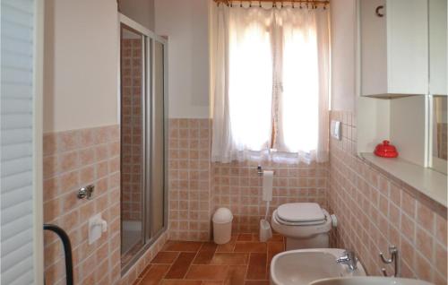 a bathroom with a toilet and a sink and a window at Casa La Montesca in Città di Castello