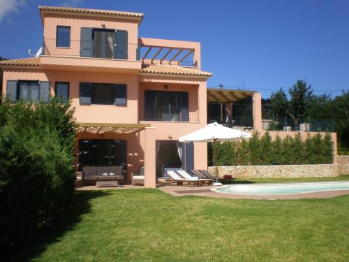 a house with a patio and a swimming pool at Villa Brio Exclusive in Skala Kefalonias