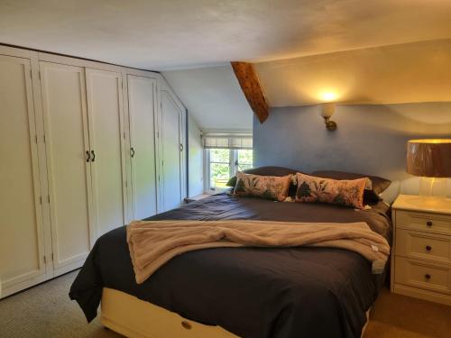 a bedroom with a large bed in a room at Bay Tree Cottage in Langford