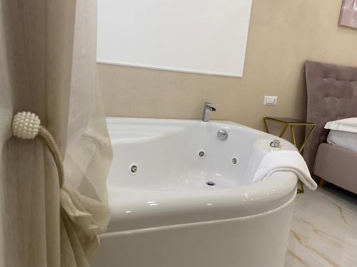 a white bath tub in a bathroom with a window at Maison De luxe in Pompei