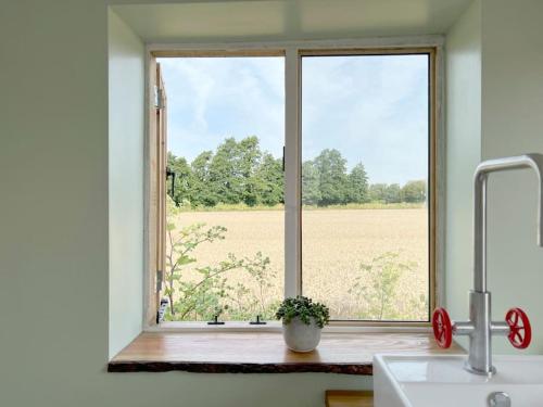 a window in a kitchen with a view of a field at The Hut in Ross on Wye