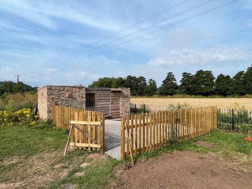 a wooden fence in front of a building at The Hut in Ross on Wye