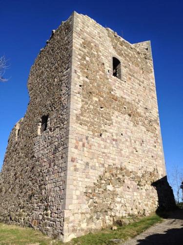 a tall stone building with two windows on it at 42 Vacanza di relax in Maremma - wifi - free parking in Castel del Piano