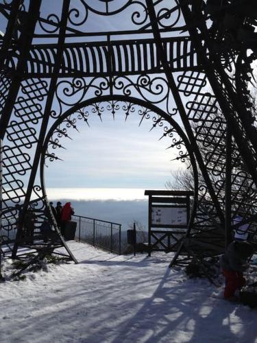 a metal gate with people sitting in the snow at 42 Vacanza di relax in Maremma - wifi - free parking in Castel del Piano