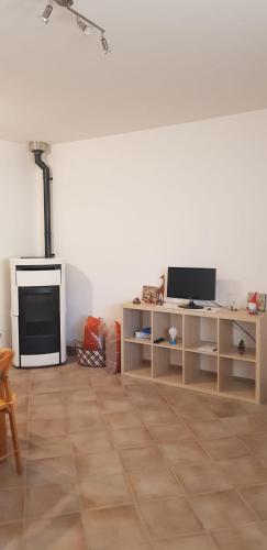a living room with a table and a television at La casa del Re in Sipicciano