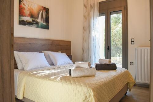 a bedroom with a large bed with towels on it at PAUL'S VILLA PLAKIAS in Plakias