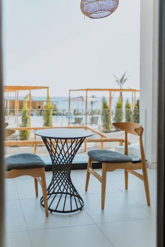 a table and chairs on a balcony with a table and chairs at Abonora Drymades in Dhërmi