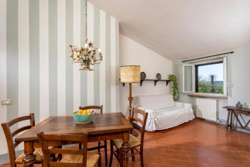 a dining room with a table and a bed at CasaLeTolfe Residence in Siena