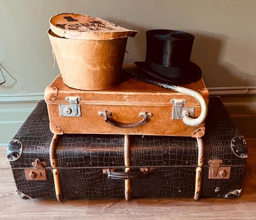 a stack of suitcases with a top hat on top at Torreby Slott Hotel & Golf in Munkedal