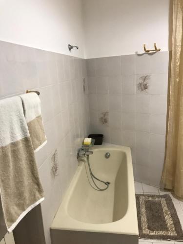 een badkamer met een bad en een handdoek bij Casa Josy in Francavilla di Sicilia