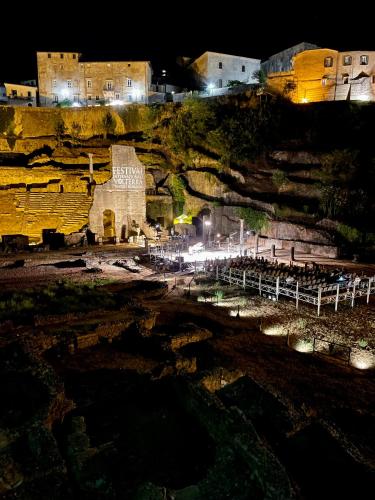 a building on a hill at night with lights at Podere Le Volpaie - Arancia in Montecatini Val di Cecina