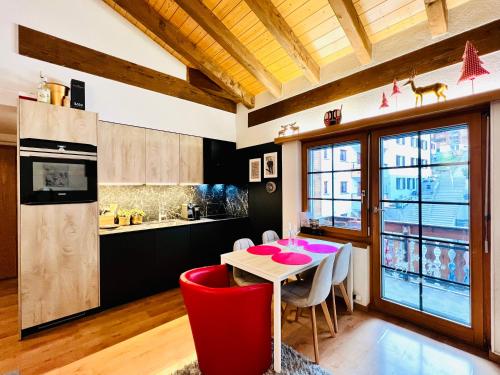 a kitchen and dining room with a table and chairs at Saas-Fee renovated flat in center of the village in Saas-Fee