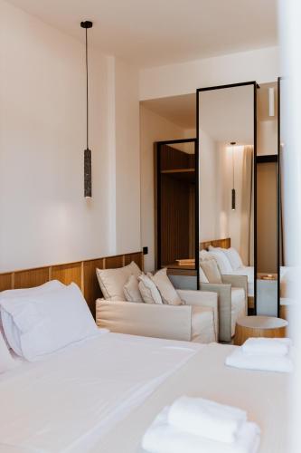 a hotel room with two beds and a mirror at Abonora Drymades in Dhërmi