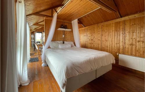 LauwerzijlにあるNice stacaravan In Lauwerzijl With Wifiの木製天井のベッドルーム1室