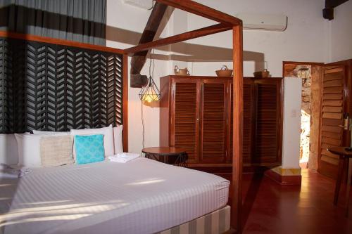 a bedroom with a bed with a wooden headboard at Casa Lisa in Acapulco