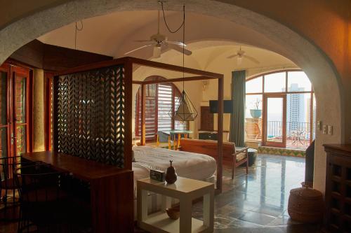 a bedroom with a bed and a table in a room at Casa Lisa in Acapulco