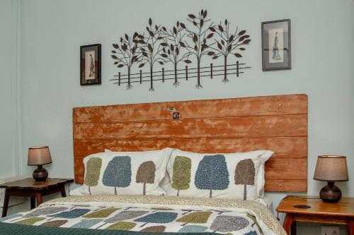 a bedroom with a bed with a wooden headboard at The Green Lantern - Howick in Howick