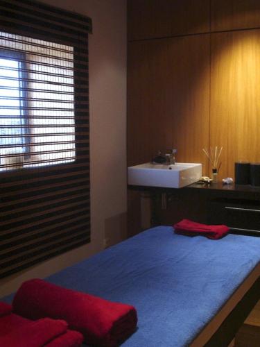 a bedroom with a bed and a sink and a sink at Estalagem Da Ponta Do Sol in Ponta do Sol