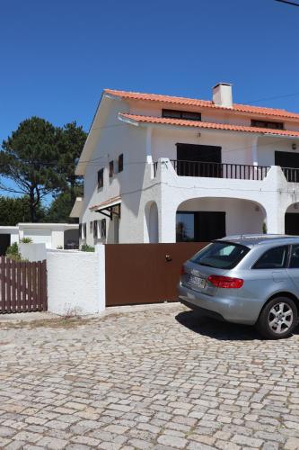 a car parked in front of a house at Casa do Cipreste in Viana do Castelo