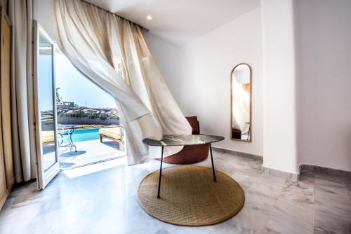 a chair in a room with a view of a pool at San Antonio Summerland in Mýkonos City