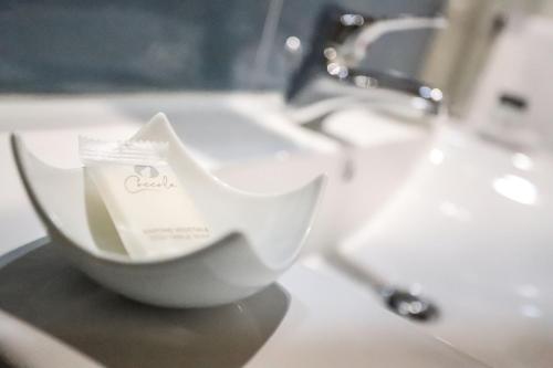 a white bowl sitting on top of a bathroom sink at Secondo Binario in Amantea