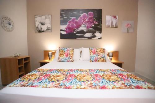 a bedroom with a bed with a colorful bedspread at Secondo Binario in Amantea