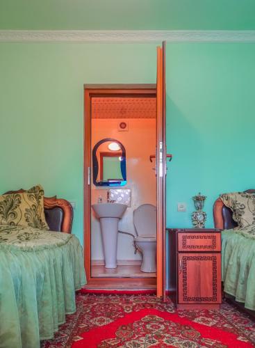 a bathroom with a sink and a toilet in a room at Aspet B&B in Tatʼev