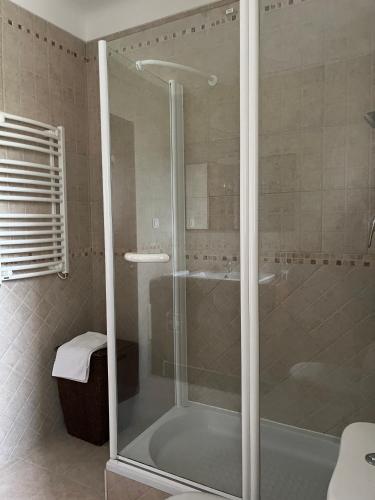 a shower with a glass door in a bathroom at Azenhas Apartment in Sintra