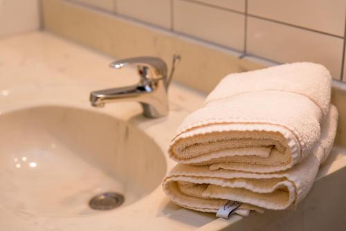 a towel sitting next to a sink in a bathroom at Landhaus Arztmann in Bodensdorf