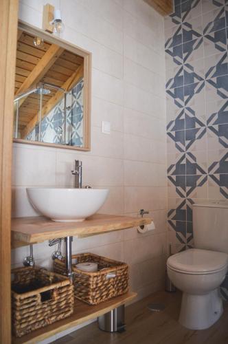 a bathroom with a sink and a toilet at Paragem dos Pacatos - Odeceixe in Odeceixe
