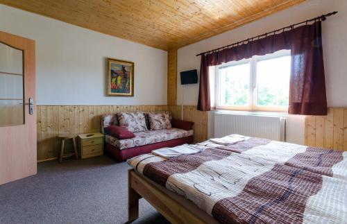 A bed or beds in a room at Penzion Pulčiny 43
