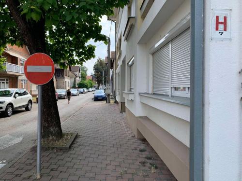 a do not enter sign on a sidewalk next to a building at Anja Apartman in Bosanski Šamac