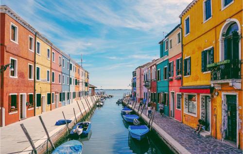 a canal between colorful buildings with boats in the water at Nice apartment in Venezia with 2 Bedrooms and WiFi in Venice