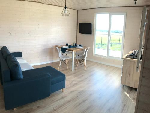 a living room with a couch and a table at BALTICO Domki Letniskowe in Sarbinowo
