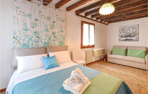 a bedroom with a large bed and a couch at Lovely Apartment In Venezia With Wifi in Venice