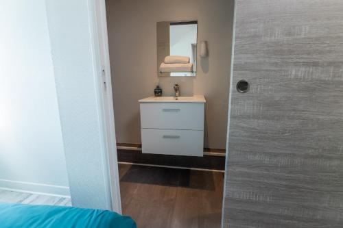 a bathroom with a sink and a mirror at Au coucher de soleil - Dormir comme à la maison - in Châteaubriant