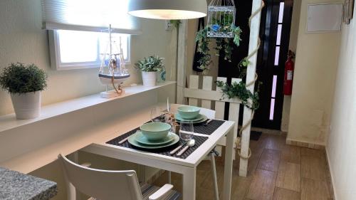 a small table with plates and bowls on it in a room at Seixal Bay House!! in Seixal