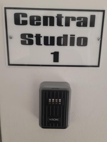 a black remote control on a wall with a sign at Central Studio 1 in Heraklio