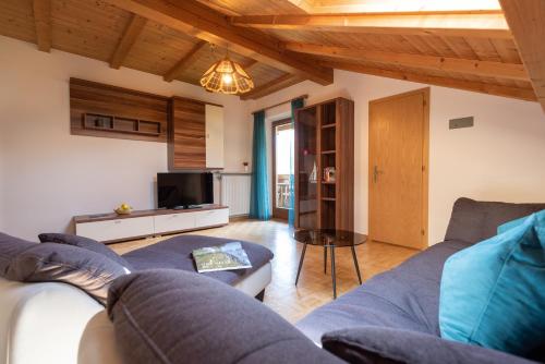 - un salon avec un canapé et une télévision dans l'établissement Pixnerhof - Urlaub am Biohof, à Castelbello