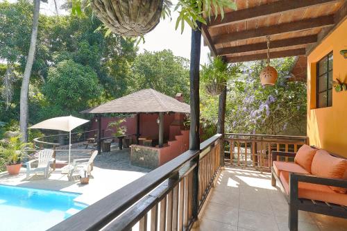 a porch of a house with a swimming pool at Villa Bayacanes con piscinas privadas in Jarabacoa