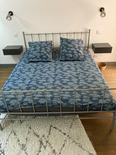 a bed with blue sheets and pillows in a room at Principale@Brandon in Brandon