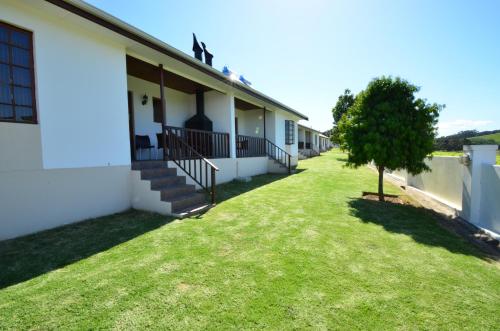 a view of the side of a building with a green yard at D'Aria Guest Cottages in Durbanville