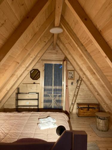 a bedroom with a bed in a attic at Tilia Cottage Banjska stena in Mitrovac