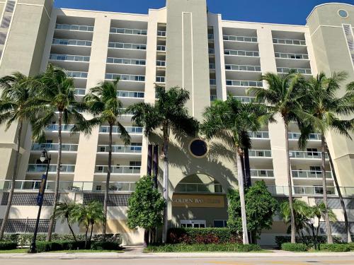 a building with palm trees in front of it at Beautiful Miami Place in Miami Beach