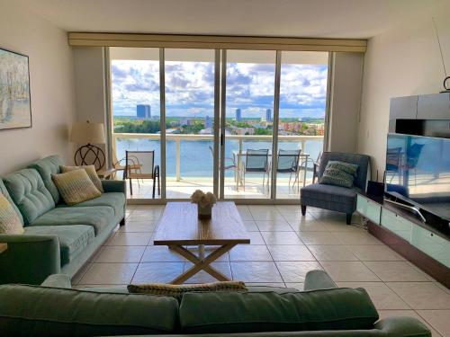 a living room with a couch and a table and a tv at Beautiful Miami Place in Miami Beach